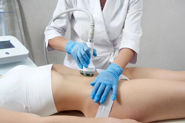 Lost the Weight but Not the Loose Skin? 2 woman having HIFU treatment on her stomach to combat loose skin Newham following weight loss